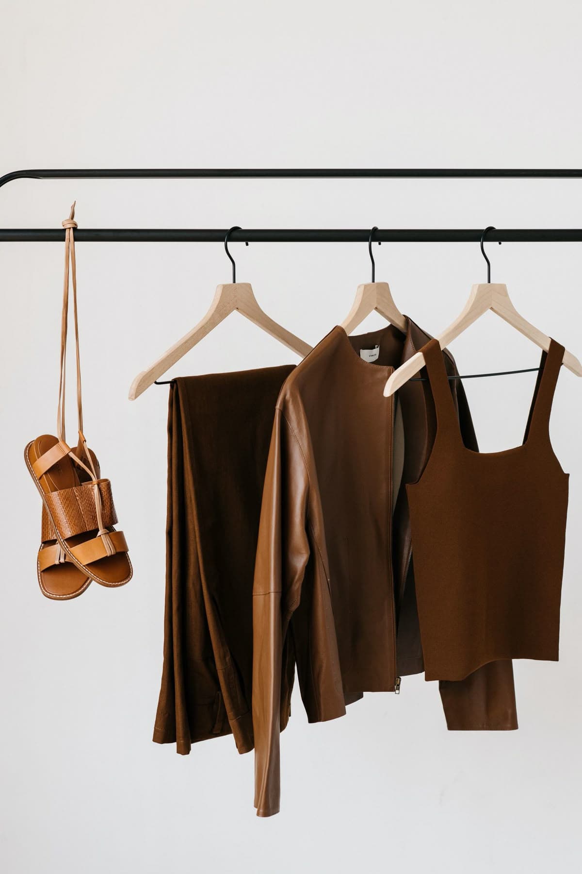 Brown leather outfit on a studio rack