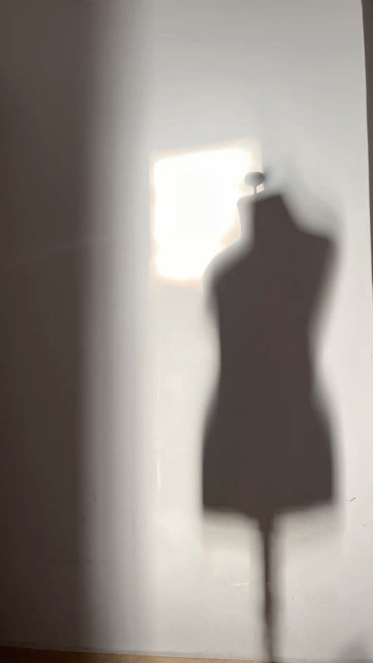 Dress form shadow on a sunlit wall